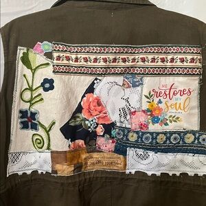 Upcycled Olive Green Sleeveless Utility Vest with applications on the back.